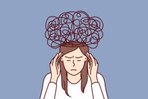 IIlustration of a woman with her hands on her temples and stressed lines surrounding her head.