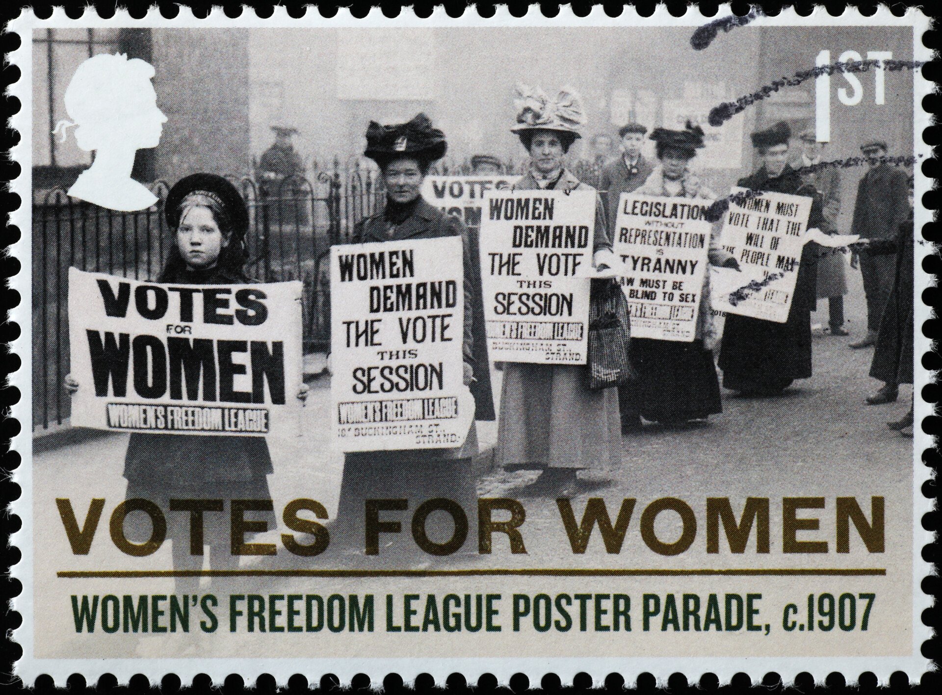 A stamp displaying women holding votes for women placards circa 1907