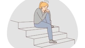 An illustration of a lonely woman sat on the stairs, looking sat.